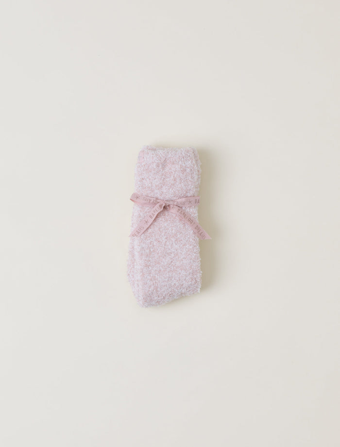 Pink textured socks on a light beige background