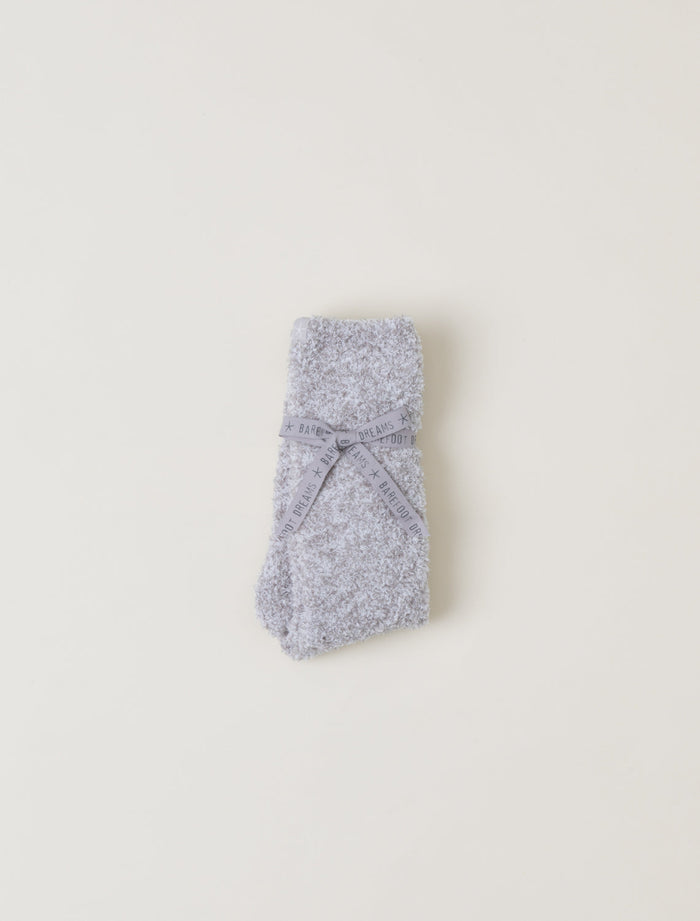 Gray knitted socks on a light beige background