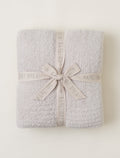 Gray textured blanket with a ribbon on a white background