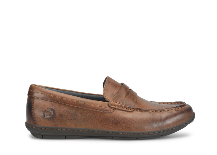 A single brown leather penny loafer shown in profile against a plain white background.