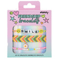 Packaged set of friendship bracelets with 'SMILE' and floral charm on a pink and blue gradient background.
