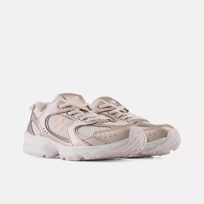 A New Balance low-top sneaker in metallic rose gold and silver mesh, featuring a chunky white midsole and a small white New Balance 'N' logo on the side.