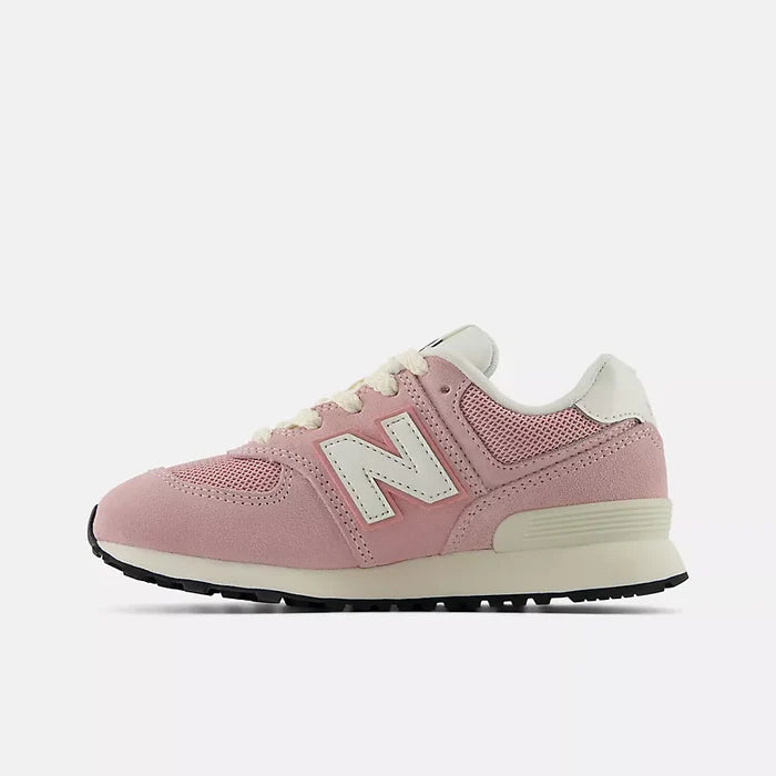 A pink New Balance sneaker with cream-colored laces, a cream midsole, and a black outsole, shown from a side profile on a light gray background.