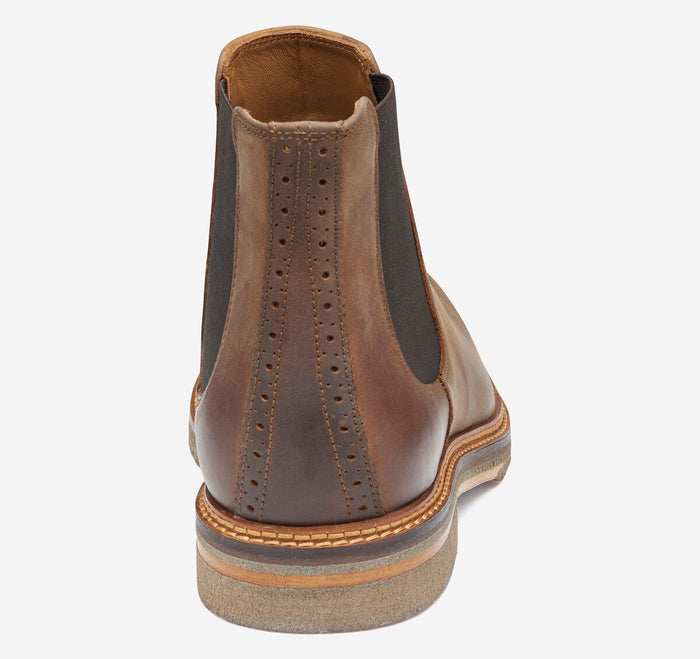 Brown leather Chelsea boot on a white background