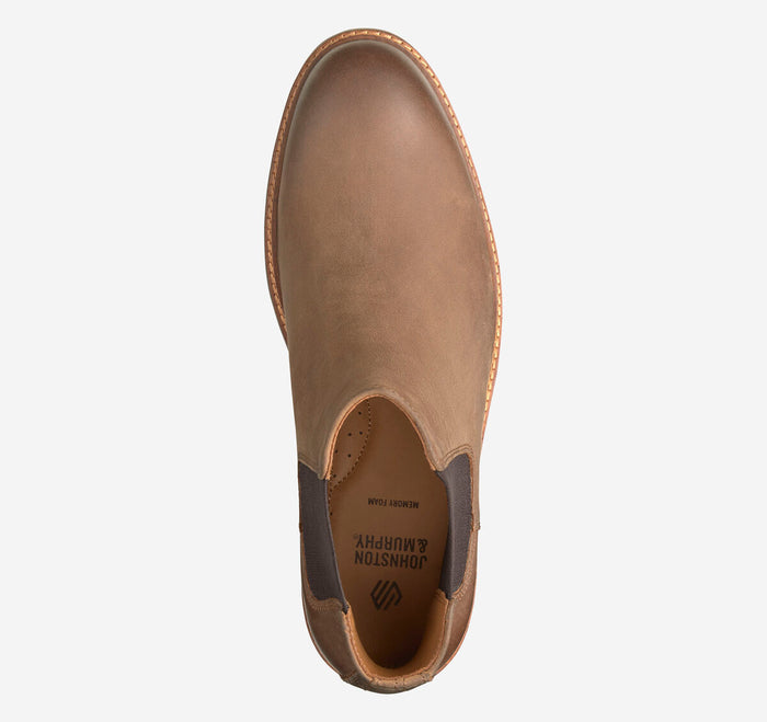 A top-down view of a brown leather ankle boot, shown on a clean white background. The brand name 'JOHNSON NORTON' is visible on the inner sole.