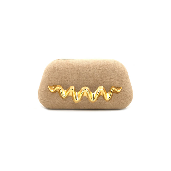 A beige suede clutch bag featuring a prominent, wavy, three-dimensional gold metal embellishment across the front, set against a plain white background.