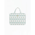 A laptop sleeve featuring a white background with a repeating teal and green geometric pattern, complete with two top handles and a small gold logo badge on the front.