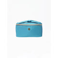 A turquoise blue zippered cosmetic bag with a top handle and a small round gold-tone logo emblem on the front, set against a plain white background.