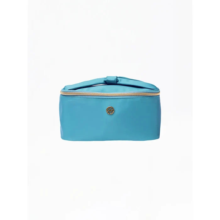 A turquoise blue zippered cosmetic bag with a top handle and a small round gold-tone logo emblem on the front, set against a plain white background.