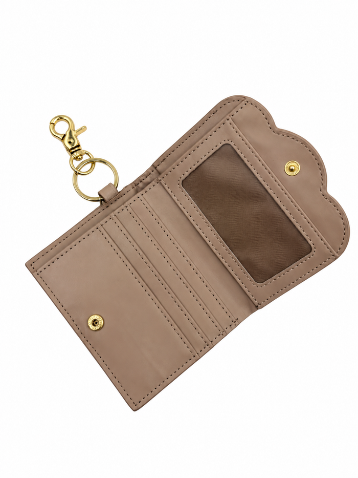 A taupe-brown leather key holder wallet with a gold-tone clasp and key ring, shown open to reveal card slots and an ID window.