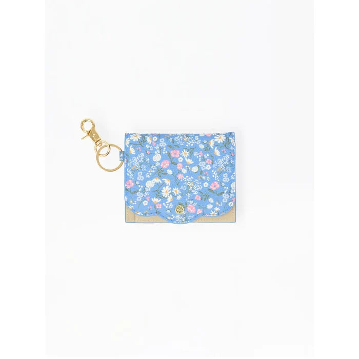 A small blue floral card holder or pouch with a gold-tone clasp and ring, shown on a plain white background.