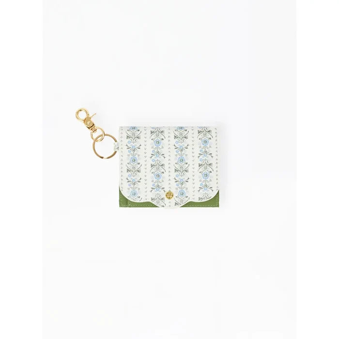 A small white card holder or clutch with a vertical floral pattern in light blue and green, featuring a gold-tone snap button and a matching gold keychain clasp, shown on a plain white background.
