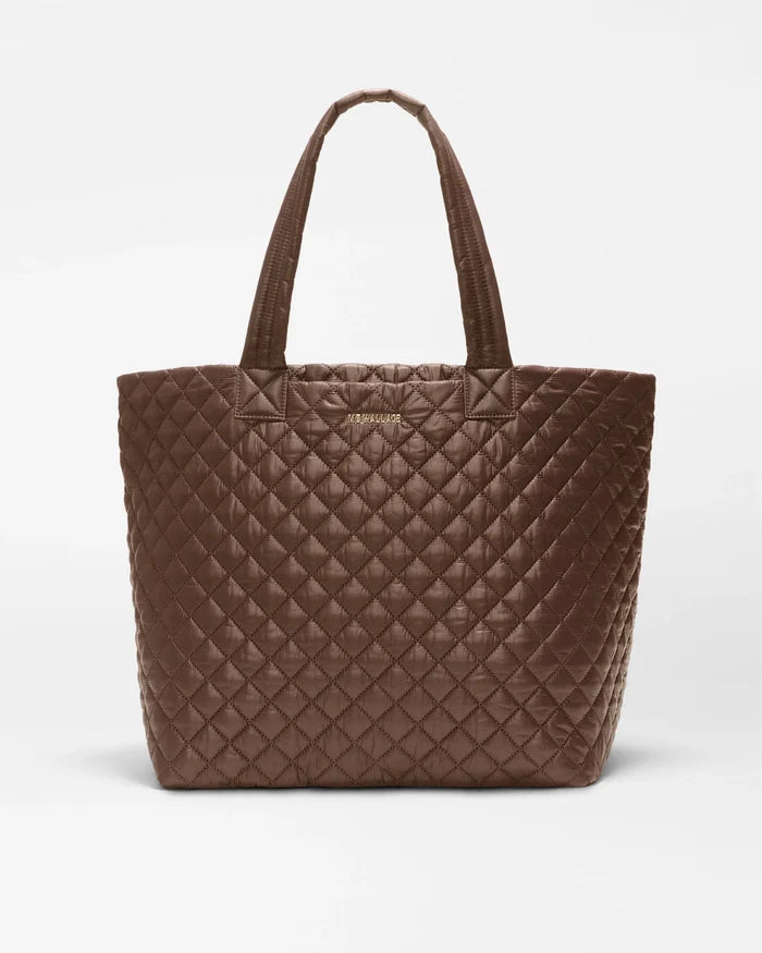 A brown quilted leather tote bag with double shoulder straps, shown against a plain light gray background.