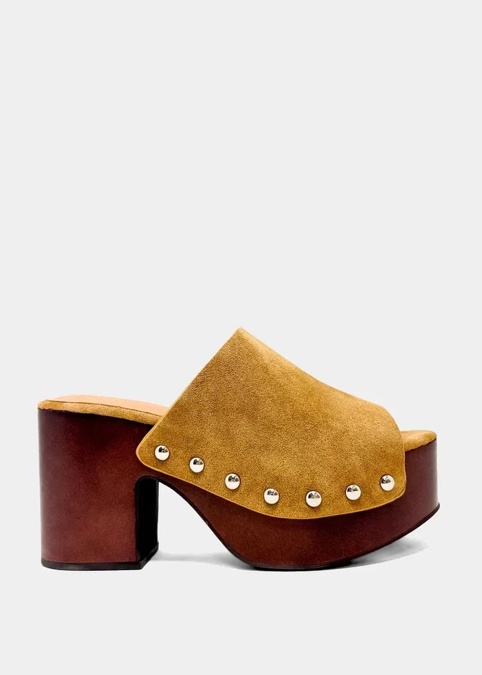 A single women's clog-style heeled mule in tan suede and dark reddish-brown wood, decorated with silver-tone studs along the strap, shown against a light gray background.