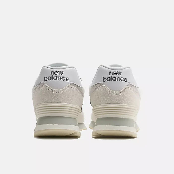 A pair of New Balance sneakers shown from the back, featuring a white and off-white suede and mesh upper with a light gray midsole and the 'new balance' logo in black on the heel tabs.